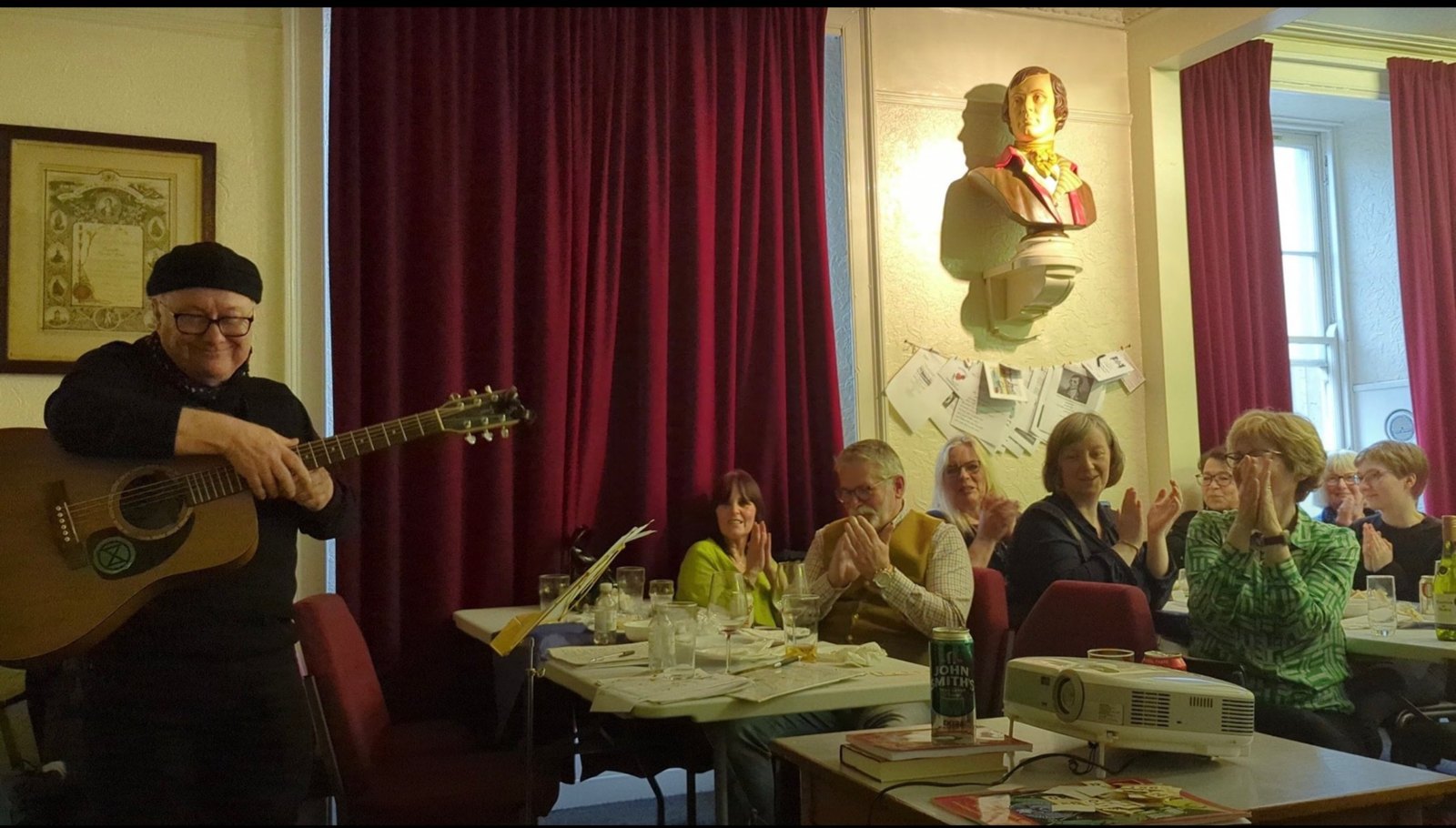 A guitarist is applauded by a full room at the Dundee Rebel City evening